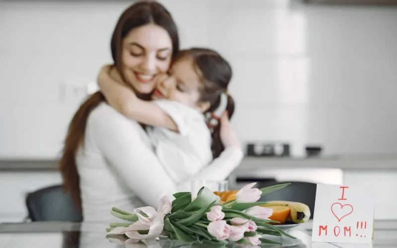 A heartwarming moment between mother and child with tulips and love note.