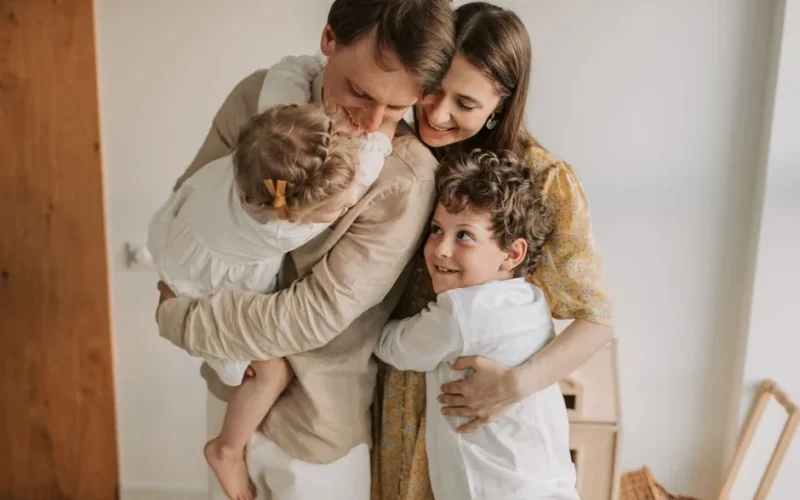 A heartwarming scene of a family hugging indoors, showcasing love and togetherness.